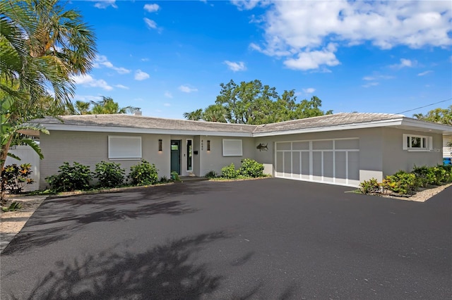 4649 Neptune Dr SE, Saint Petersburg, FL 33705 - ranch-style house featuring an attached garage, driveway, and stucco siding
