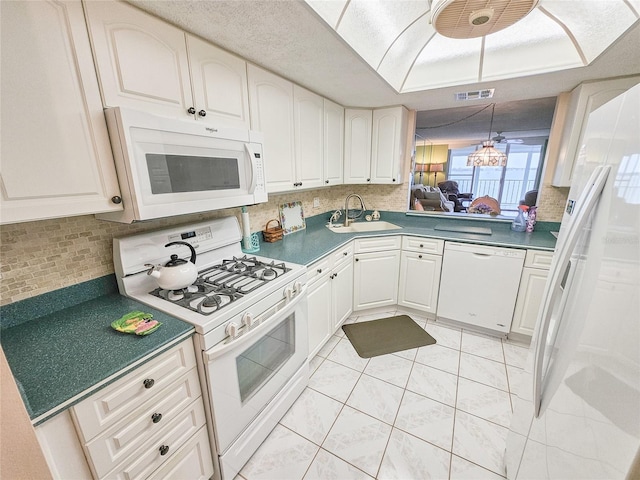 6060 Shore Dr S Unit 906, Gulfport, FL 33707 - kitchen with white appliances, a sink, decorative backsplash, and light tile patterned floors