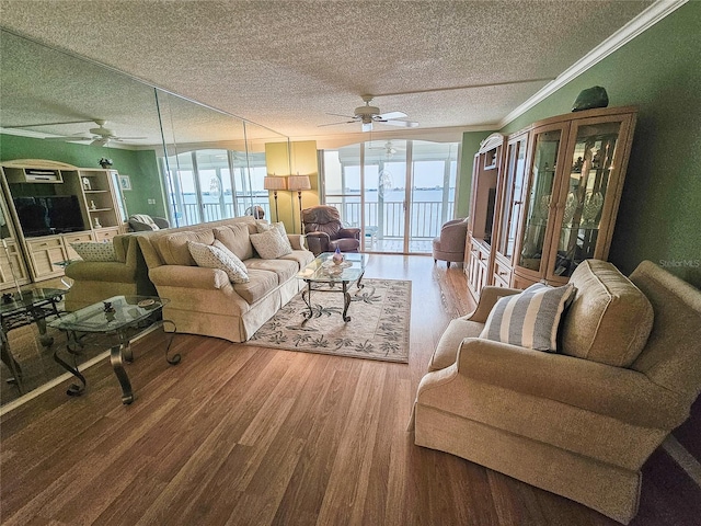 6060 Shore Dr S Unit 906, Gulfport, FL 33707 - living room featuring a ceiling fan, a textured ceiling, wood finished floors, and ornamental molding