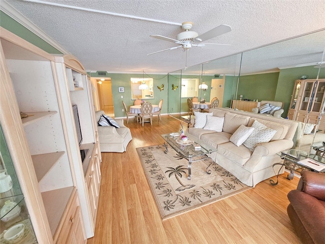 6060 Shore Dr S Unit 906, Gulfport, FL 33707 - living area with ceiling fan, wood finished floors, and a textured ceiling
