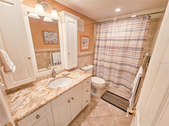 6060 Shore Dr S Unit 906, Gulfport, FL 33707 - bathroom featuring vanity, tile walls, toilet, tile patterned floors, and a wainscoted wall