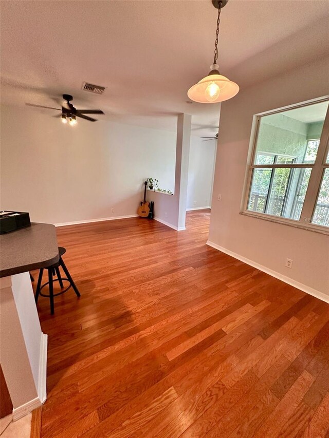 608 Black Lion Dr NE, Saint Petersburg, FL 33716 - dining area featuring a ceiling fan, wood finished floors, and baseboards