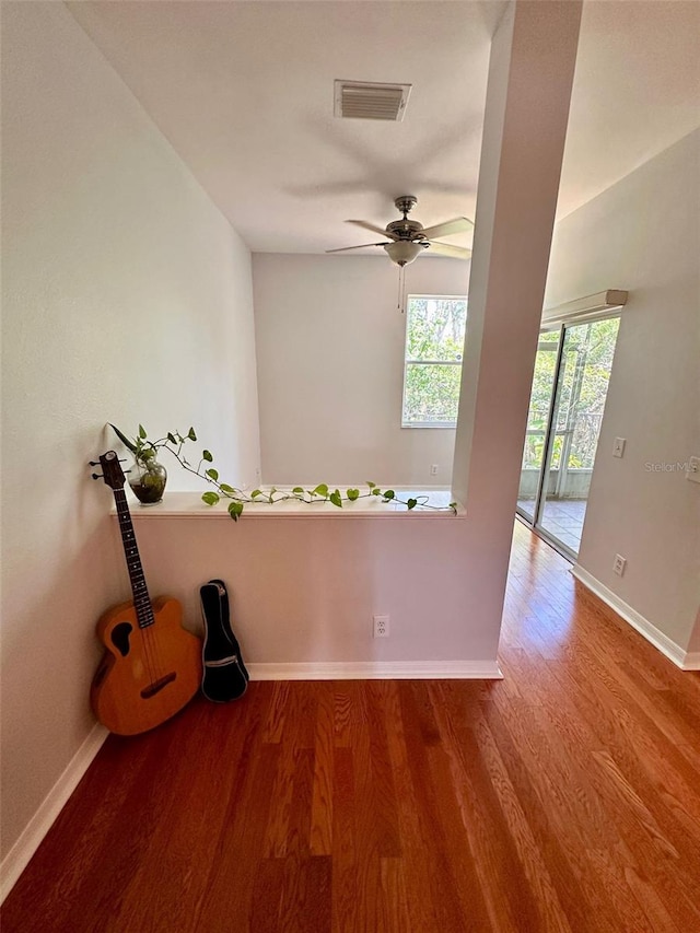 608 Black Lion Dr NE, Saint Petersburg, FL 33716 - spare room featuring wood finished floors, baseboards, and a ceiling fan