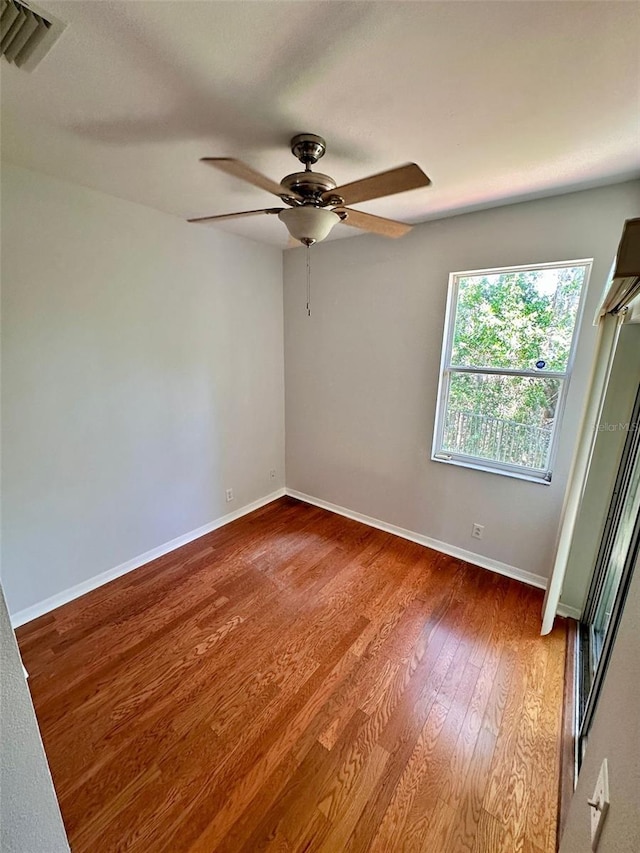 608 Black Lion Dr NE, Saint Petersburg, FL 33716 - unfurnished room featuring wood finished floors, baseboards, and a ceiling fan