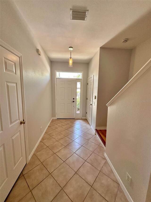 608 Black Lion Dr NE, Saint Petersburg, FL 33716 - entrance foyer featuring light tile patterned flooring, baseboards, and stairway