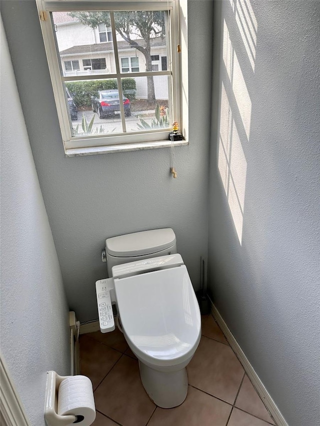 608 Black Lion Dr NE, Saint Petersburg, FL 33716 - bathroom with toilet, tile patterned flooring, and baseboards