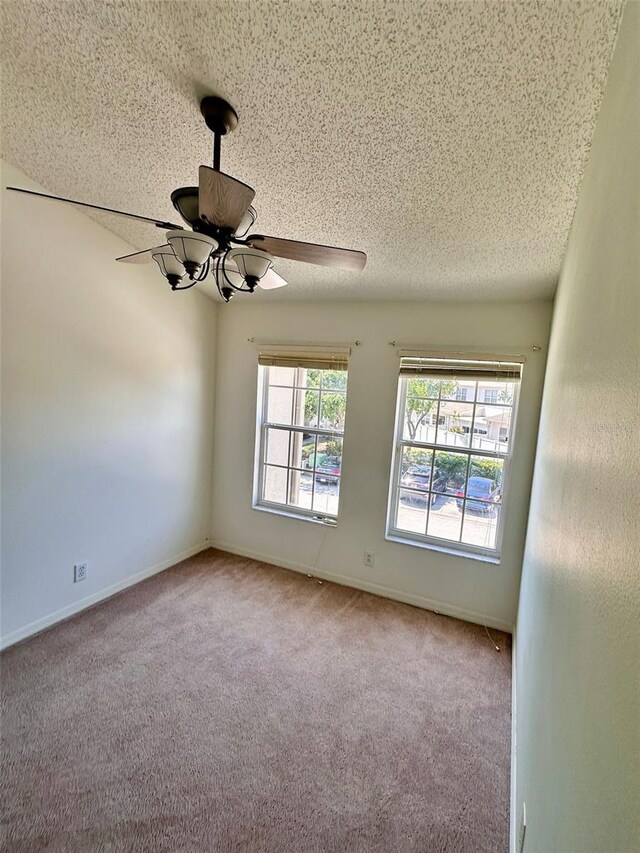 608 Black Lion Dr NE, Saint Petersburg, FL 33716 - empty room with a ceiling fan, carpet, a textured ceiling, and baseboards