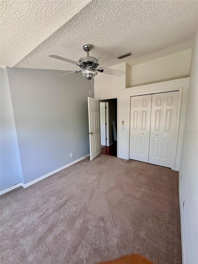608 Black Lion Dr NE, Saint Petersburg, FL 33716 - unfurnished bedroom with carpet flooring, a closet, baseboards, a ceiling fan, and a textured ceiling