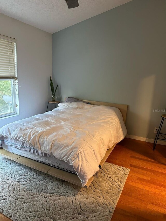 608 Black Lion Dr NE, Saint Petersburg, FL 33716 - bedroom featuring wood finished floors, baseboards, and a textured ceiling