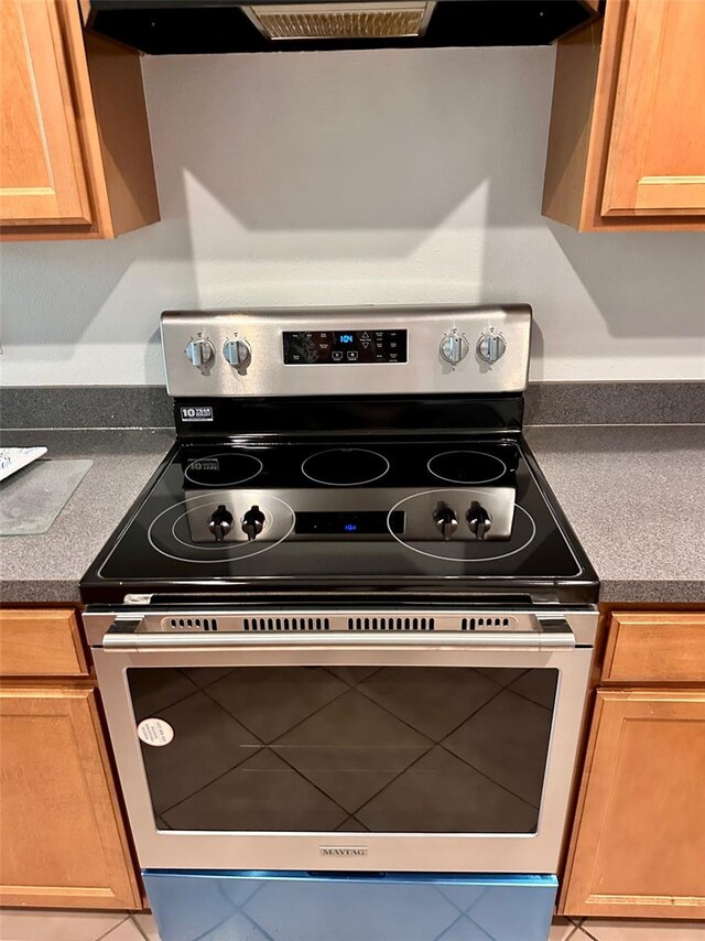 608 Black Lion Dr NE, Saint Petersburg, FL 33716 - kitchen view of electric range, dark countertops, and extractor fan