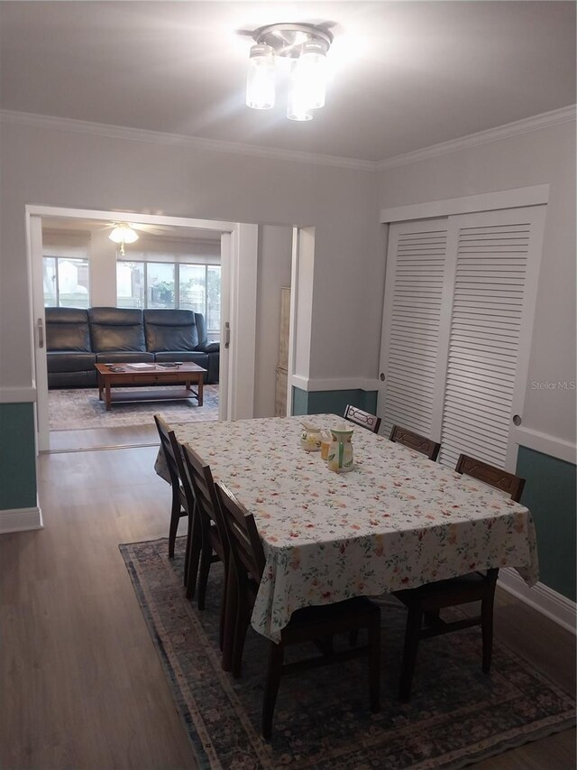 10142 118th Ave, Largo, FL 33773 - dining room with wood finished floors, crown molding, and baseboards