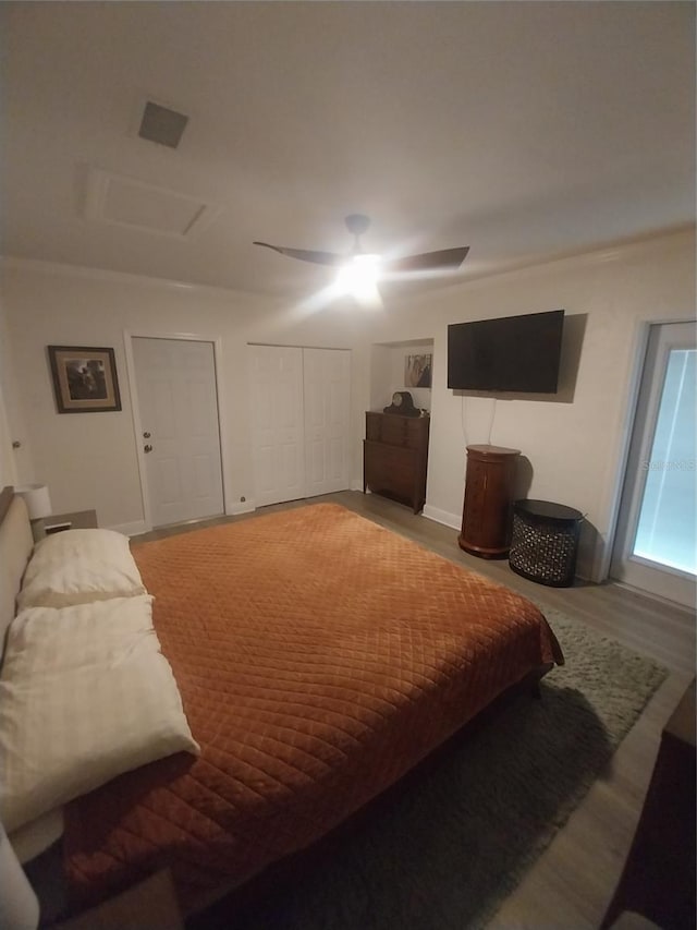 10142 118th Ave, Largo, FL 33773 - bedroom with wood finished floors, ceiling fan, and attic access