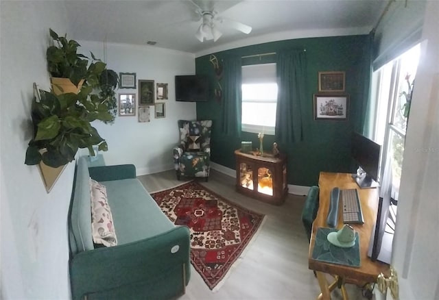 10142 118th Ave, Largo, FL 33773 - living room with wood finished floors, a ceiling fan, and baseboards