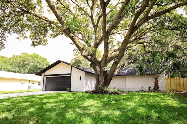 4260 Saint Lawrence Dr, New Port Richey, FL 34655 - view of front of house with a garage, driveway, and stucco siding