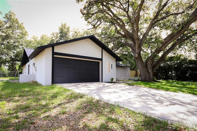 4260 Saint Lawrence Dr, New Port Richey, FL 34655 - view of front of house with a garage, stucco siding, and concrete driveway