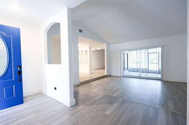 4260 Saint Lawrence Dr, New Port Richey, FL 34655 - foyer featuring baseboards, wood finished floors, and vaulted ceiling