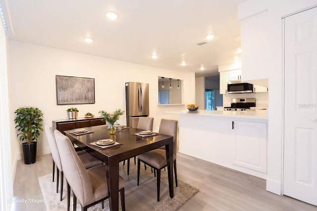 4260 Saint Lawrence Dr, New Port Richey, FL 34655 - dining space featuring light wood-type flooring and recessed lighting