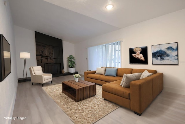 4260 Saint Lawrence Dr, New Port Richey, FL 34655 - living room featuring light wood-style flooring, baseboards, and vaulted ceiling