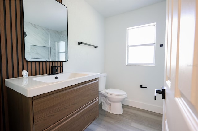 4260 Saint Lawrence Dr, New Port Richey, FL 34655 - bathroom featuring vanity, toilet, wood finished floors, and baseboards