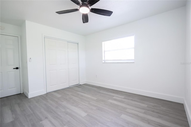 4260 Saint Lawrence Dr, New Port Richey, FL 34655 - unfurnished bedroom featuring light wood-style floors, baseboards, a closet, and a ceiling fan