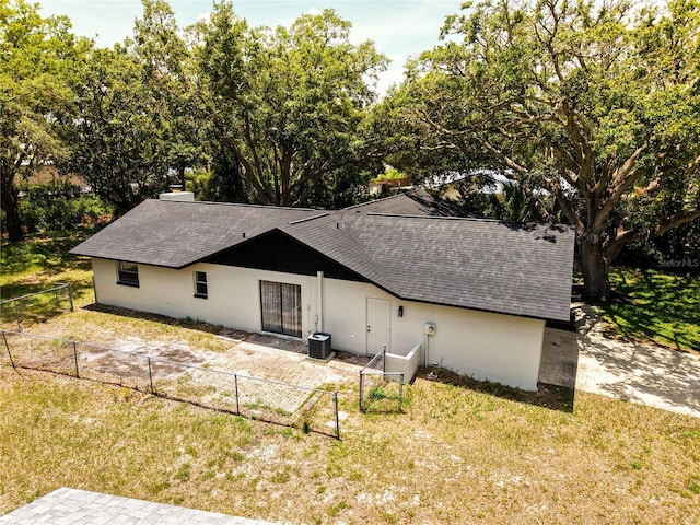 4260 Saint Lawrence Dr, New Port Richey, FL 34655 - back of property with roof with shingles and central air condition unit