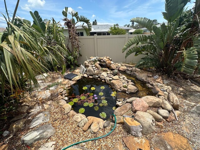 1559 San Roy Dr, Dunedin, FL 34698 - view of yard with a garden pond