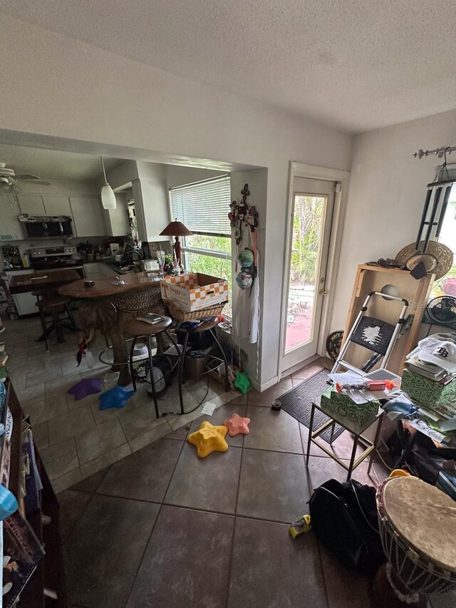 1559 San Roy Dr, Dunedin, FL 34698 - tiled dining space with a textured ceiling and ceiling fan