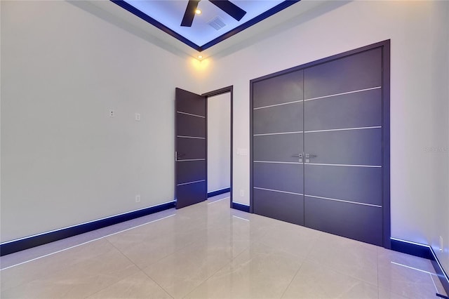6534 Simone Shores Cir, Apollo Beach, FL 33572 - unfurnished bedroom featuring tile patterned flooring, ceiling fan, baseboards, and a closet