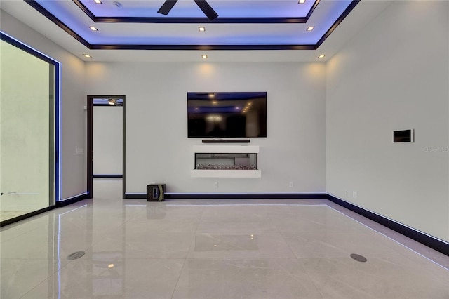 6534 Simone Shores Cir, Apollo Beach, FL 33572 - unfurnished living room with a tray ceiling, ceiling fan, and baseboards