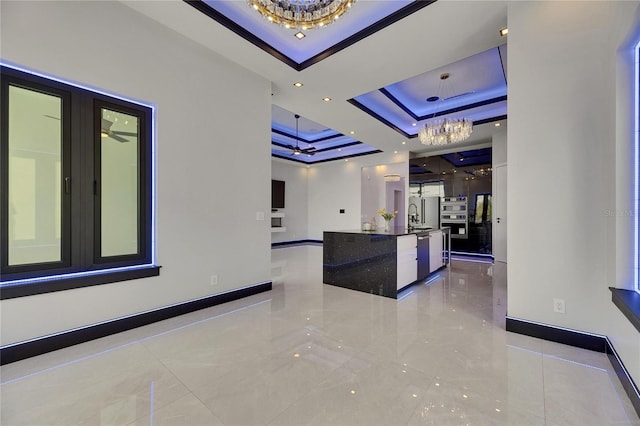 6534 Simone Shores Cir, Apollo Beach, FL 33572 - corridor featuring a raised ceiling, a chandelier, and baseboards