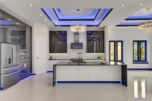 6534 Simone Shores Cir, Apollo Beach, FL 33572 - bar area featuring a chandelier, high quality fridge, a sink, a raised ceiling, and recessed lighting