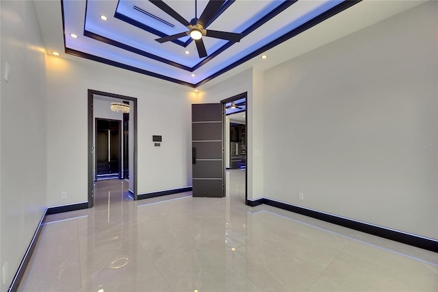 6534 Simone Shores Cir, Apollo Beach, FL 33572 - empty room with a ceiling fan, baseboards, a tray ceiling, recessed lighting, and a high ceiling