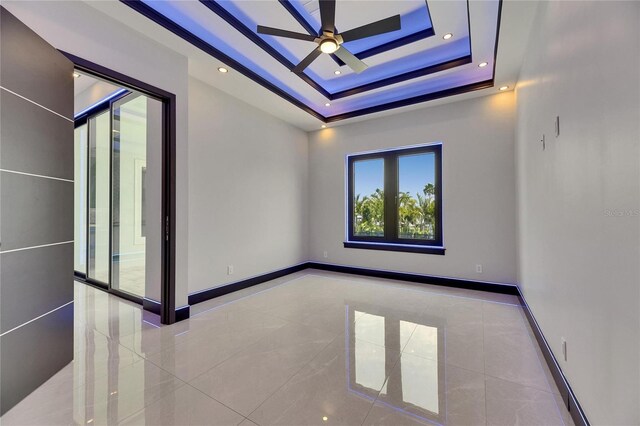6534 Simone Shores Cir, Apollo Beach, FL 33572 - unfurnished room with ceiling fan, tile patterned floors, a raised ceiling, baseboards, and recessed lighting