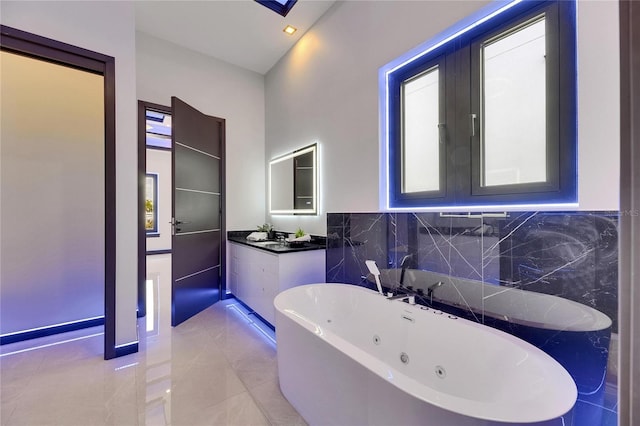 6534 Simone Shores Cir, Apollo Beach, FL 33572 - bathroom featuring a tub with jets and vanity