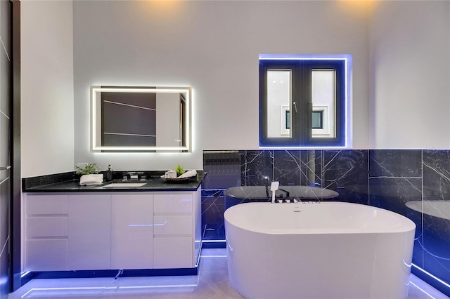 6534 Simone Shores Cir, Apollo Beach, FL 33572 - full bath featuring tile walls, a soaking tub, vanity, and wainscoting
