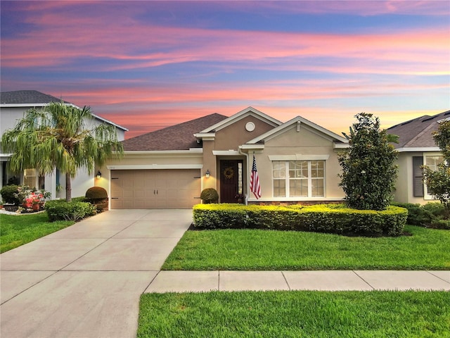 17610 Buckingham Garden Dr, Lithia, FL 33547 - single story home featuring a garage, a lawn, stucco siding, and driveway
