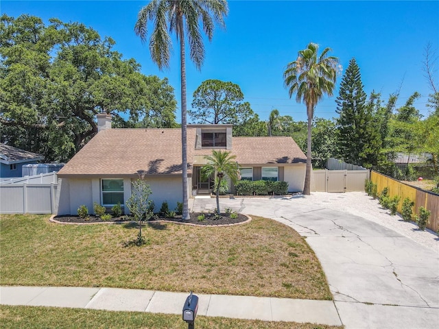 3968 Orchard Hill Cir, Palm Harbor, FL 34684 - view of front facade with a gate, a chimney, curved driveway, and roof with shingles