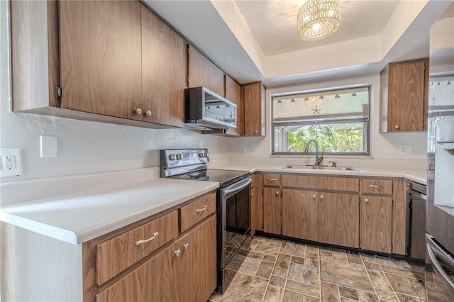 3968 Orchard Hill Cir, Palm Harbor, FL 34684 - kitchen featuring stainless steel microwave, black electric range oven, a sink, light countertops, and a raised ceiling