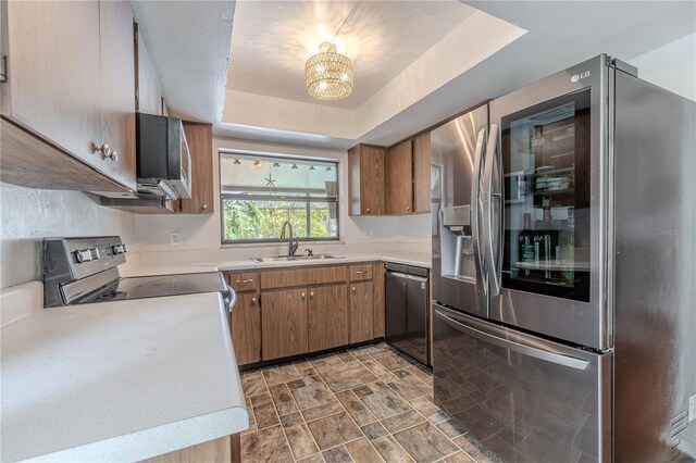 3968 Orchard Hill Cir, Palm Harbor, FL 34684 - kitchen featuring appliances with stainless steel finishes, light countertops, a sink, and brown cabinetry