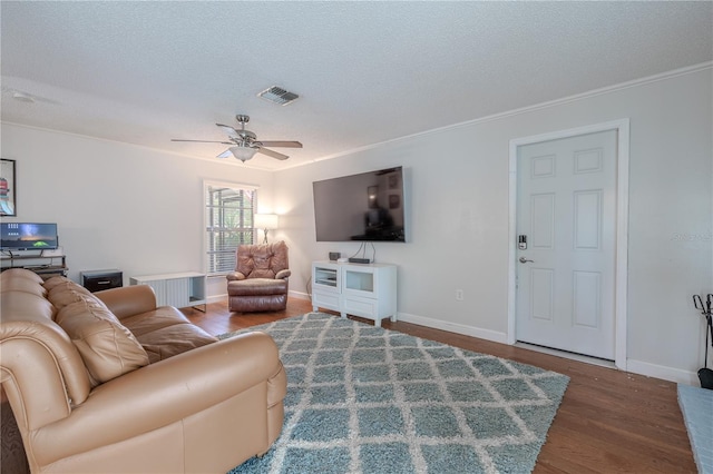 3968 Orchard Hill Cir, Palm Harbor, FL 34684 - living room with wood finished floors, a textured ceiling, a ceiling fan, crown molding, and baseboards