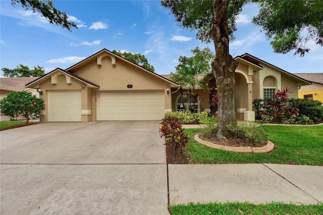 905 Balsamina Dr, Brandon, FL 33510 - view of front facade with stucco siding, an attached garage, concrete driveway, and a front lawn