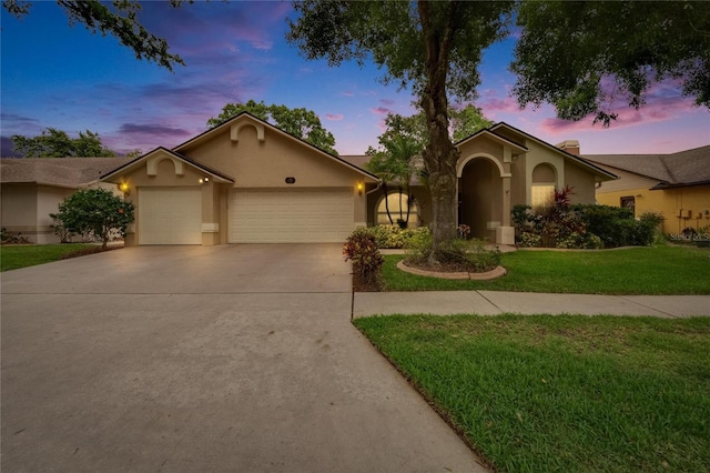 905 Balsamina Dr, Brandon, FL 33510 - view of front of property with stucco siding, an attached garage, concrete driveway, and a front lawn