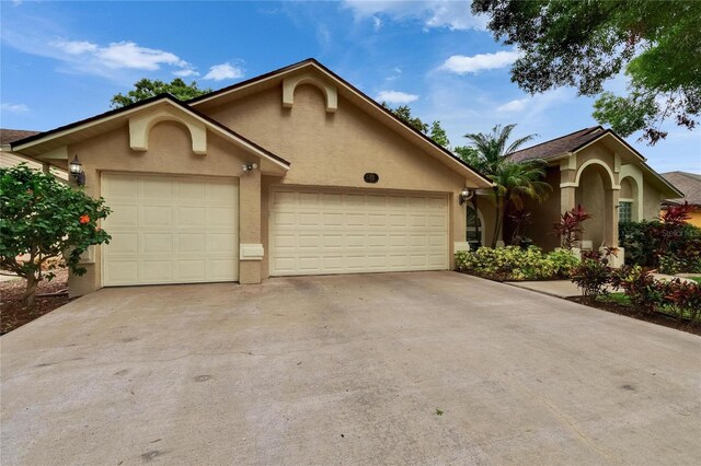 905 Balsamina Dr, Brandon, FL 33510 - view of front facade with stucco siding, an attached garage, and concrete driveway