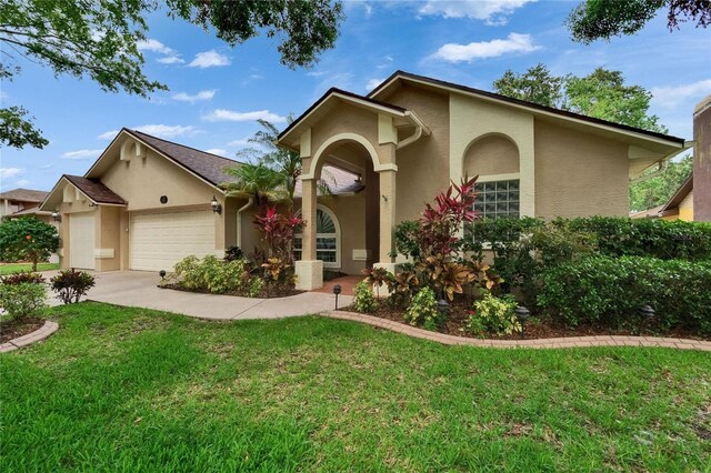 905 Balsamina Dr, Brandon, FL 33510 - view of front of home featuring stucco siding, an attached garage, a front yard, and concrete driveway