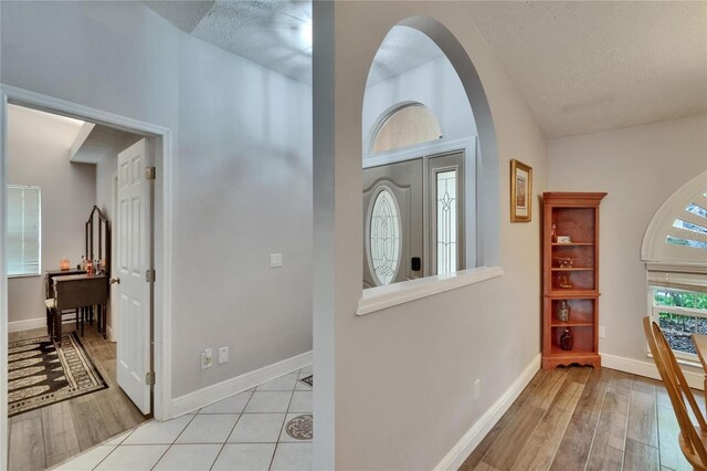 905 Balsamina Dr, Brandon, FL 33510 - entrance foyer featuring a textured ceiling, light wood-style floors, baseboards, and arched walkways
