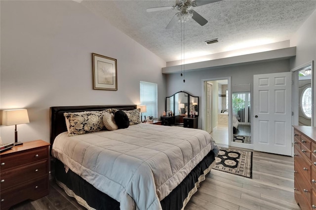 905 Balsamina Dr, Brandon, FL 33510 - bedroom with wood finished floors, a textured ceiling, lofted ceiling, ensuite bath, and ceiling fan