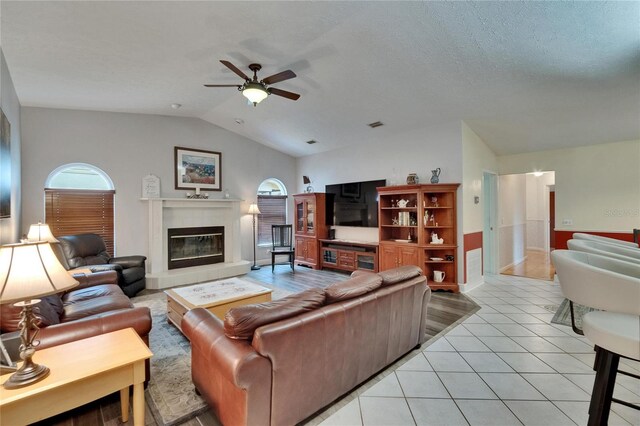 905 Balsamina Dr, Brandon, FL 33510 - living area featuring a ceiling fan, a tile fireplace, vaulted ceiling, and light tile patterned flooring