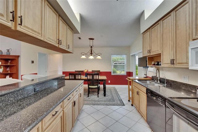 905 Balsamina Dr, Brandon, FL 33510 - kitchen with black appliances, a sink, light tile patterned floors, decorative light fixtures, and dark stone countertops