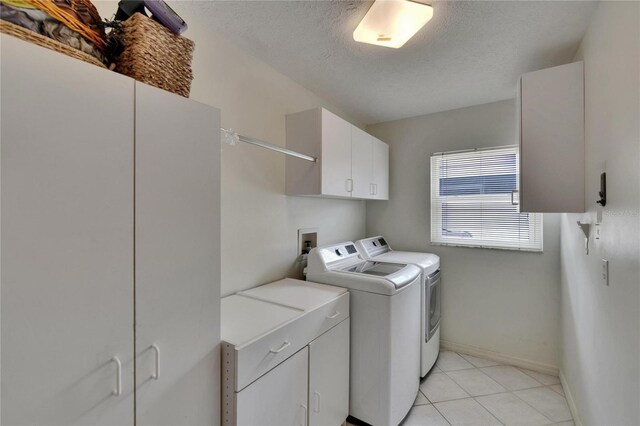 905 Balsamina Dr, Brandon, FL 33510 - laundry room with cabinet space, independent washer and dryer, baseboards, light tile patterned floors, and a textured ceiling