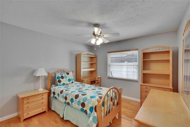 905 Balsamina Dr, Brandon, FL 33510 - bedroom with light wood finished floors, baseboards, a textured ceiling, and a ceiling fan